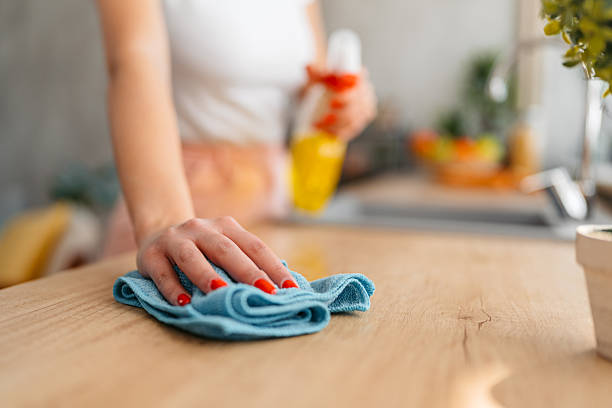 beautiful young woman wiping the kitchen counter. close up.